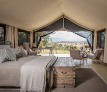 In the heart of the Maasai Mara National Reserve, on the banks of the Mara River, stands Entim Camp. The camp offers friendly staff, luxury accommodation and prime location. During the famous Great Migration, guests at the camp might catch one of the famed wildebeest