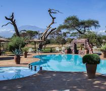 On the edge of Amboseli National Park, Sentrim Amboseli Camp has striking views of Mt Kilimanjaro. The camp is located near Olkelunyiet Gate. 

 

There are 60 en-suite tents, made up of 34 doubles, 16 twins and 10 triples. All tents are equipped with electronic safety deposit box, minibar, fan,